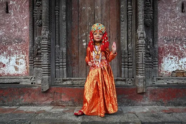 A girl dressed as a living goddess “Kumari” poses for a photograph before taking part in the “Kumari Puja” rituals at the Hanuman Dhoka at Durbar Square in Kathmandu on September 27, 2023.  (Photo by Prakash Mathema/AFP Photo)