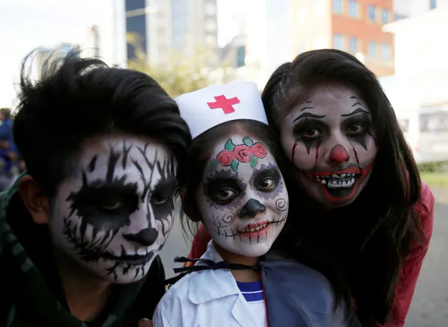 People in costume pose for a photograph during Halloween celebrations in La Paz, Bolivia on October 31, 2018. (Photo by David Mercado/Reuters)