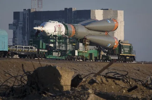Russia's Soyuz-FG booster rocket with the space capsule Soyuz TMA-16M that will carry a new crew to the International Space Station (ISS) is transported from a hangar to the launch pad in Russian leased Baikonur cosmodrome, Kazakhstan, Wednesday, March 25, 2015. (Photo by Dmitry Lovetsky/AP Photo)
