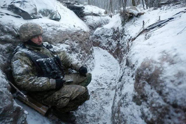 A picture made available on 29 December 2016 shows an Ukrainian serviceman as he rests during a combat with pro-Russian rebels, as Ukrainians are in a trapped position during their counterattack near the Luganske village, 18,5 km north of Debaltseve, near Donetsk, Ukraine, 28 December 2016. According to media reports, exchanges of fire between pro-Russian rebels and Ukrainian troops have reportedly increased in the Donetsk area in spite of Minsk agreement. (Photo by Vadim Kudinov/EPA)