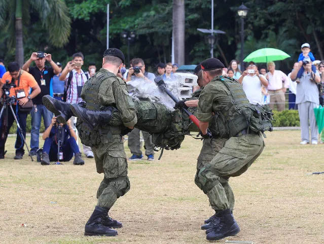 A member of the Russian Marines, who are stationed onboard the anti-submarine vessel Admiral Tributs, uses a sledge hammer to break two hollow blocks on top of his comrade during a public demonstration of capabilities at Luneta National Park in Metro Manila, Philippines January 5, 2017. (Photo by Romeo Ranoco/Reuters)