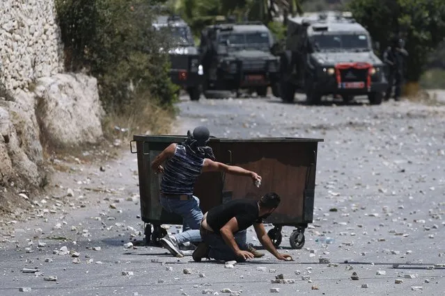 Palestinians clash with Israeli security forces following the funeral of Mohammed al-Alami, 12, in the village of Beit Ummar, near the West Bank city of Hebron, Thursday, July 29, 2021 (Photo by Majdi Mohammed/AP Photo)