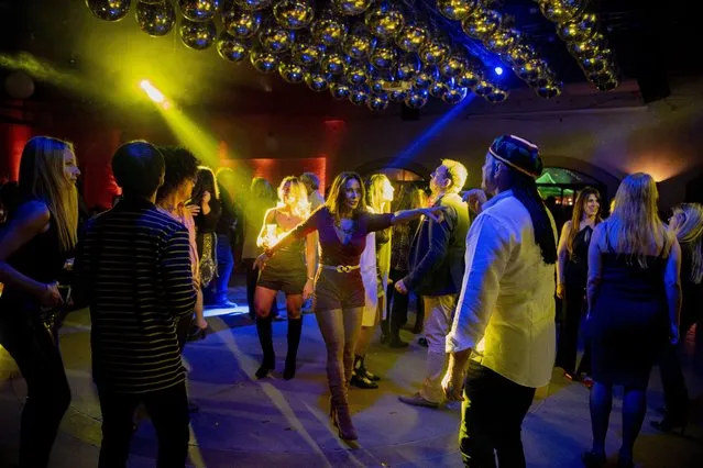 People dance during a “Night of Nostalgia” event at La Quinta de Arteaga salon on the outskirts of Montevideo, Uruguay, Tuesday, August 24, 2021, during the COVID-19 pandemic.. (Photo by Matilde Campodonico/AP Photo)