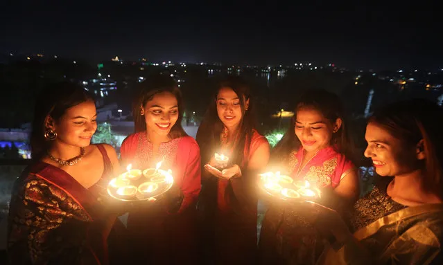 Women light lamps on the eve of Diwali, or the Festival of Lights, in Bhopal, capital of India's Madhya Pradesh state, October 23, 2022. (Photo by Xinhua News Agency/Rex Features/Shutterstock)
