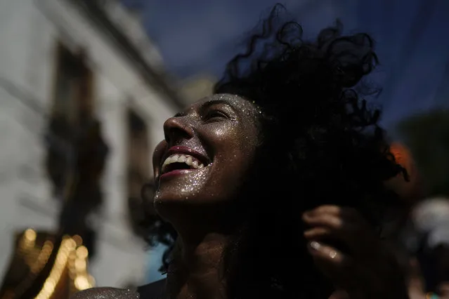A reveler dances during the “Ceu na Terra” or Heaven on Earth street party in Rio de Janeiro, Brazil, Saturday, February 23, 2019. Merrymakers take to the streets in hundreds of open-air “bloco” parties ahead of Rio's over-the-top Carnival, the highlight of the year for many. (Photo by Leo Correa/AP Photo)