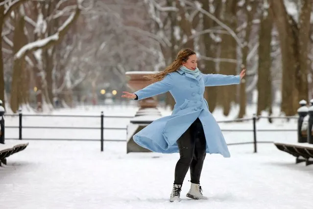 Zoe-Daphnee Gagne, 21, of Manhattan, dances in Central Park during the first snowfall in over 700 days in New York City on January 16, 2024. (Photo by Andrew Kelly/Reuters)