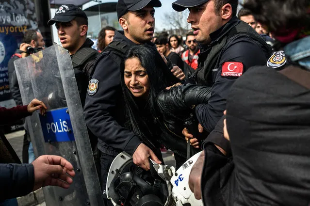 Turkish anti riot police officers detain a woman on March 6, 2016, during a march in Kadikoy district in Istanbul to mark International Women's Day. (Photo by Ozan Kose/AFP Photo)