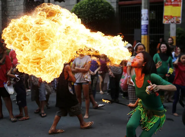 A Filipino dancer performs with fire to mark the Chinese Lunar New Year in Manila's Chinatown, Philippines, 28 January 2017. Chinese around the world celebrate the Lunar New Year on 28 January 2017, the first day of the year of rooster. (Photo by Francis R. Malasig/EPA)