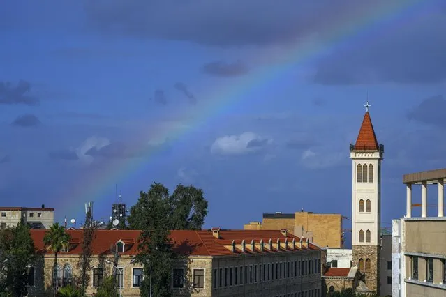 A rainbow appears over a church in downtown Beirut, Lebanon, Monday, November 27, 2023. (Photo by Bilal Hussein/AP Photo)