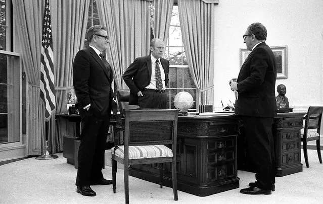 In this April 28, 1975 photo provided the White House via the Gerald R. Ford Library, President Gerald Ford, center, meets with Secretary of State Henry Kissinger, right, and Vice President Nelson Rockefeller in the Oval Office of the White House to discuss the American evacuation of Saigon. (Photo by David Hume Kennerly/White House, Gerald R. Ford Library via AP Photo)