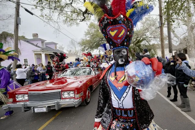 A member of the traditional Mardi Gras group The Tramps holds a traditional coconut throw during the Krewe of Zulu Parade on Mardi Gras Day in New Orleans, Tuesday, February 13, 2024. (Photo by Matthew Hinton/AP Photo)