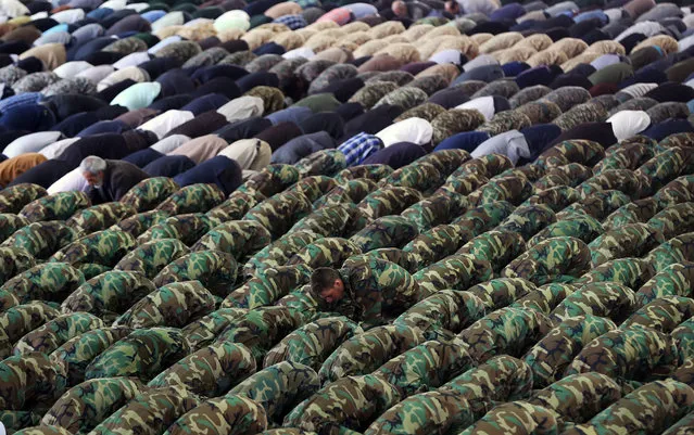Members of Iranian army and revolutionary guards corps (IRGC), pray during a weekly Friday Prayer ceremony in Tehran, Iran, 12 April 2019. Media reported Iranian Ayatollah Ali Mowahedi Kermani threats Israel as saying in his speech that, 'Mr. Trump don't play with lion tail' (referring to US government on 08 April 2019 said it had designated Iran's revolutionary guards corps (IRGC) as a terrorist organization), the IRGC could destroy Israel with its missiles. (Photo by Abedin Taherkenareh/EPA/EFE)