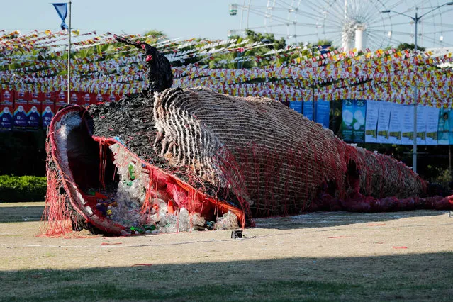 A 24-meter-long whale sculpture called “Cry of the Dead Whale” by Biboy Royong sits on the sand at the Cultural Center of the Philippines in Pasay city, Philippines, 26 April 2019. The whale like art installation made by Filipino artist Biboy Royong was inspired by a sperm whale that washed ashore in Samal Island, Davao del Norte, which died from plastic waste found in its stomach. The sculpture is made of plastic waste that had washed up on beaches across the Philippines. (Photo by Mark R. Cristino/EPA/EFE)