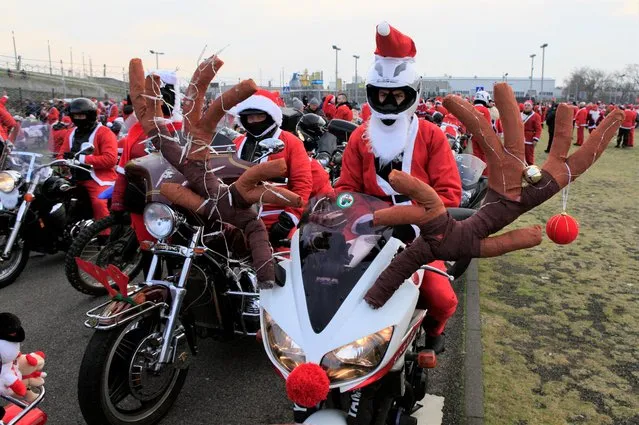 Motorcyclists wait for the start of “Santa Clauses on motorbikes”, a parade aimed to fund Christmas packages and hot meals for children in need, in Gdansk, Poland, December 5, 2021. (Photo by Radu Sigheti/Reuters)