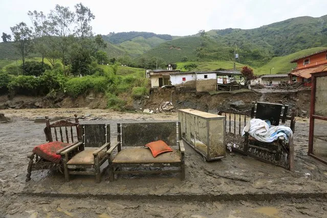 Furniture are seen in front of the ruins of houses, after a landslide close to the municipality of Salgar in Antioquia department, Colombia May 19, 2015. (Photo by Jose Miguel Gomez/Reuters)