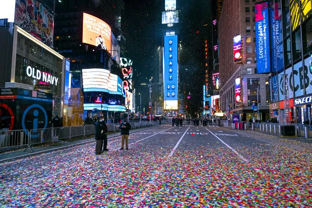 Confetti lies on the street after the Times Square New Year's Eve ball dropped in a nearly empty Times Square early Friday, January 1, 2021, as the area normally packed with revelers was closed because of the ongoing coronavirus pandemic. (Photo by Craig Ruttle/AP Photo)