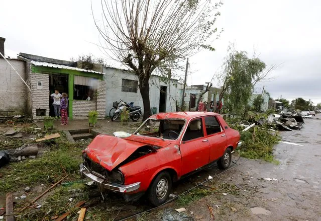 A damaged vehicle is seen amidst debris in Dolores, the day after the city was hit by a tornado, April 16, 2016. (Photo by Andres Stapff/Reuters)