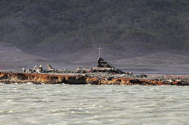 A general view shows the ruins of a church at the old sunken town of Pantabangan in Nueva Ecija province on April 24, 2024. Remnants of the centuries-old town of Pantabangan reemerged in the northern Philippines after a dam's water level dropped amid a drought that plagues many parts of the country. (Photo by Jam Sta Rosa/AFP Photo)