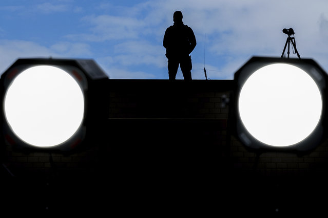 A member of the U.S. Secret Service sniper team stands watch before President Joe Biden speaks on the collapse of the Francis Scott Key Bridge, Friday, April 5, 2024, in Dundalk, Md. (Photo by Julia Nikhinson/AP Photo)