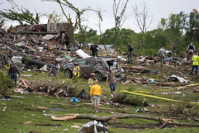 Workers search through the remains of tornado-damaged homes, Tuesday, May 21, 2024, in Greenfield, Iowa. (Photo by Charlie Neibergall/AP Photo)