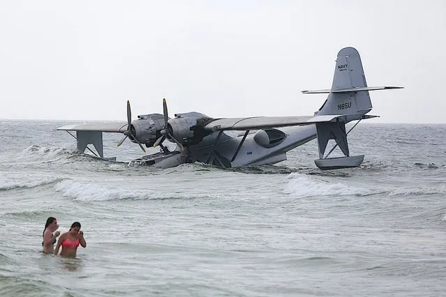 In this June 30, 2015 photo, a vintage PBY-6A flying boat rests on the sandy bottom of the Gulf of Mexico, just off the shore near Orange Beach, Ala. The aircraft took on water and became stranded while it was being used in the filming of the Nicolas Cage movie “USS Indianapolis: Men of Courage”. (Photo by Brian Kelly/Al.com via AP Photo)