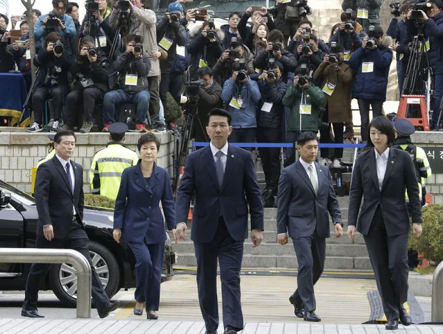 Ousted South Korean President Park Geun-hye, second from left, arrives at the Seoul Central District Court for hearing on a prosecutors' request for her arrest for corruption, in Seoul, South Korea, Thursday, March 30, 2017. (Photo by Ahn Young-joon/AP Photo)