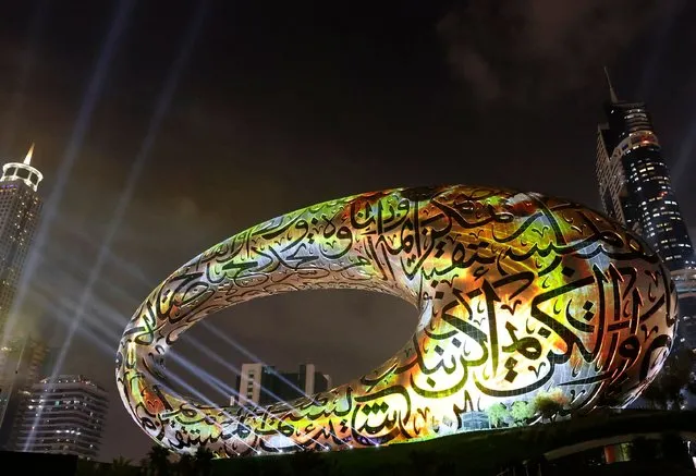 The Museum of the Future is lit up during its opening ceremony, in the gulf emirate of Dubai, on February 22, 2022. (Photo by Karim Sahib/AFP Photo)