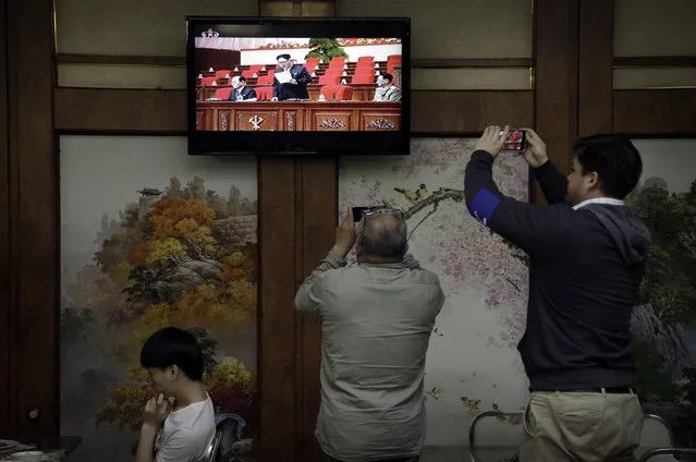 Restaurant diners watch a broadcast of the 7th Congress of the Workers' Party of Korea on local television, where North Korean leader Kim Jong Un is seen delivering a speech on Friday, May 6, 2016, in Pyongyang, North Korea. (Photo by Wong Maye-E/AP Photo)