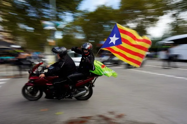 Motorcyclists drive with an “Estelada” (Catalan separatist flag) attached to their bike on Catalonia's national day “La Diada” in Barcelona, Spain on September 11, 2019. (Photo by Juan Medina/Reuters)