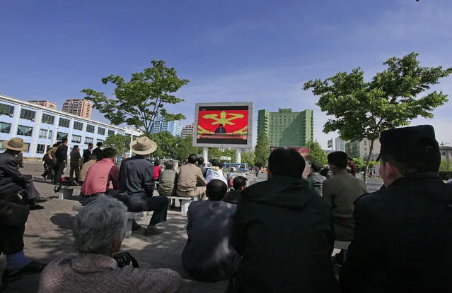 People listen to North Korean leader Kim Jong Un speak at the party congress during a television broadcast on a public screen near the Pyongyang train station on Sunday, May 8, 2016, in Pyongyang, North Korea. North Korean leader Kim Jong Un said during a critical ruling party congress that his country will not use its nuclear weapons first unless its sovereignty is invaded, state media reported. (Photo by Kim Kwang Hyon/AP Photo)