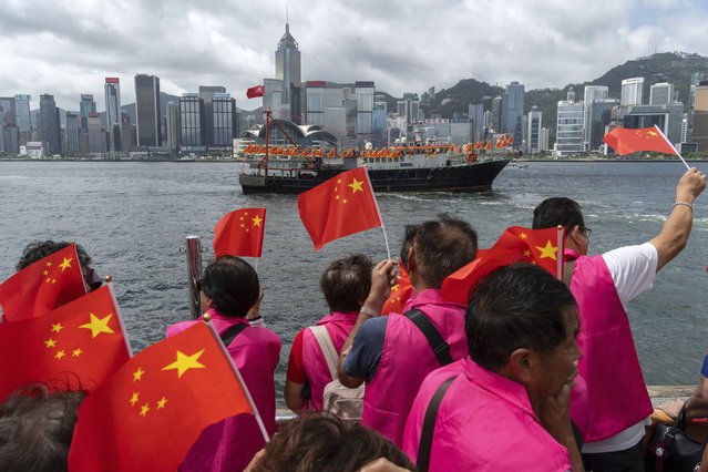 Pro-Beijing supporters hold Chinese flags to mark the 27th anniversary of Hong Kong's return to Chinese rule in Hong Kong, Monday, July 1, 2024. (Photo by Chan Long Hei/AP Photo)