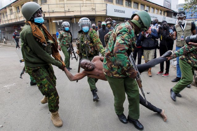 Police officers detain a man during a demonstration over police killings of people protesting against Kenya's proposed finance bill 2024/2025, in Nairobi, Kenya, on June 27, 2024. (Photo by Monicah Mwangi/Reuters)