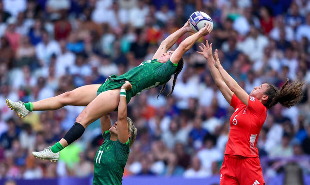 Emily Lane and Erin King of Ireland in action with Lauren Torley of Britain in the women's rugby seven on July 30, 2024. (Photo by Phil Noble/Reuters)