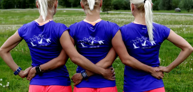 Estonia's olympic team female marathon runners triplets (L-R) Leila, Liina and Lily Luik pose during a training session in Tartu, Estonia, May 26, 2016. The shirts read “Trio for Rio”. (Photo by Ints Kalnins/Reuters)