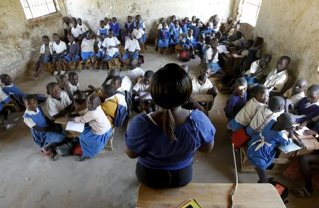 Lynette Akinyi, a school teacher, leads a class at the Senator Obama primary school in the village of Kogelo, west of Kenya's capital Nairobi, July 16, 2015. (Photo by Thomas Mukoya/Reuters)