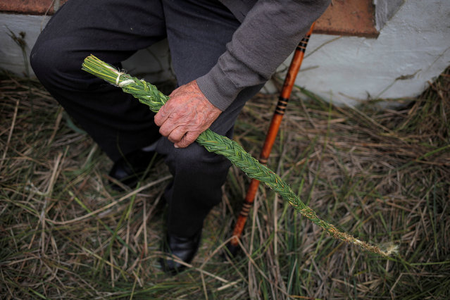 A man holds a “cachiporra” (a traditional whip made of grass) during Corpus Christi day in Zahara de la Sierra, southern Spain, May 29, 2016. (Photo by Jon Nazca/Reuters)