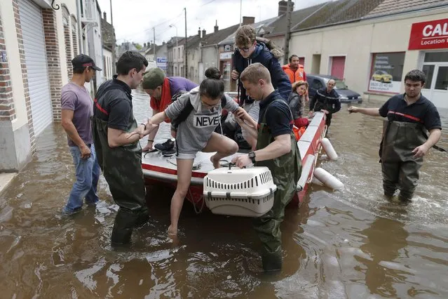 French firefighters use a small boat to evacuate residents from a flooded area after heavy rainfall in Montargis, near Orleans, June 1, 2016. (Photo by Christian Hartmann/Reuters)