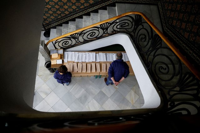 People prepare to vote at a polling station during regional elections in Madrid, Spain on May 28, 2023. (Photo by Juan Medina/Reuters)