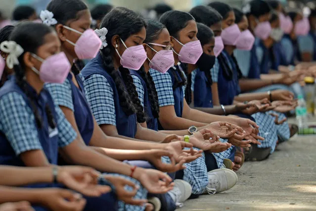 Students meditate before appearing for their 12th standard board examination at a school in Chennai on May 5, 2022. (Photo by Arun Sankar/AFP Photo)