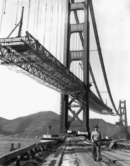 A workman walks on the levee that connects Fort Point to the south tower of the Golden Gate Bridge while it is under construction, San Francisco, California, October 1936. (Photo by Underwood Archives/Getty Images)