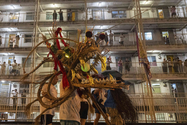 A fire dragon made of straw studded with incense sticks, is paraded during the Fire Dragon Dance performance in Hong Kong, Tuesday, September 17, 2024. (Photo by Chan Long Hei/AP Photo)