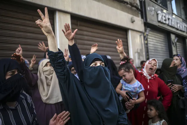 Women protesters shout slogans during a demonstration in the northern town of El Hoceima, Morocco, Thursday, July 20, 2017. Clashes between police and Moroccan protesters Thursday left at least 83 injured in clouds of tear gas and running battles at an unauthorized demonstration over inequality and corruption. (Photo by Therese Di Campo/AP Photo)