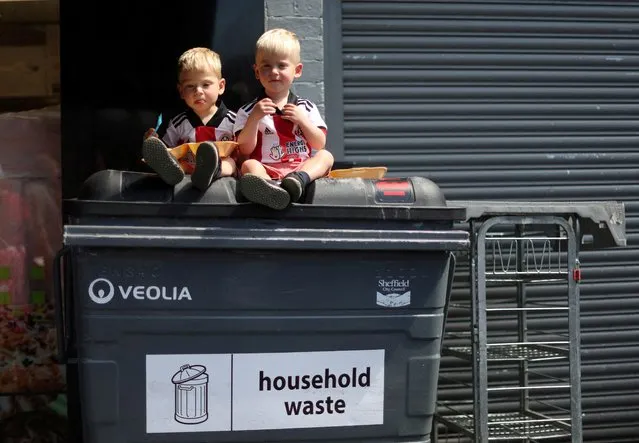 Young Sheffield United fans sit on a bin outside the stadium before a match in Sheffield, Britain on May 14, 2022. (Photo by Carl Recine/Action Images via Reuters)