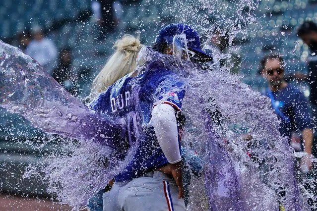Texas Rangers' Ezequiel Duran is doused after the team defeated the Chicago White Sox in a baseball game in Chicago, Sunday, June 12, 2022. (Photo by Nam Y. Huh/AP Photo)