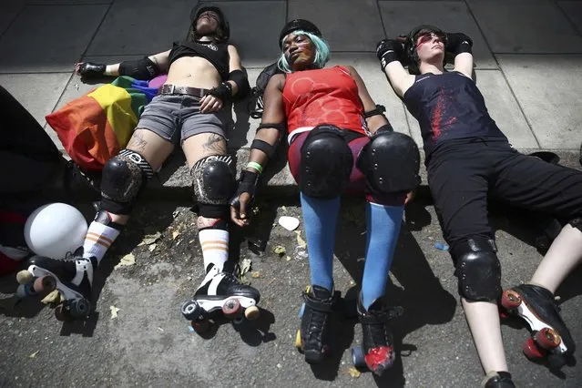 Participants rest as take part in the annual Pride London Parade, which highlights issues of the gay, lesbian and transgender community, in London, Britain June 25, 2016. (Photo by Neil Hall/Reuters)