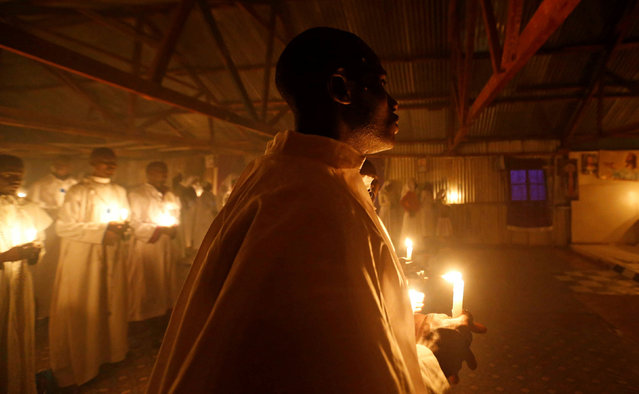 Christian faithful of the Legio Maria African Mission church hold candles as they attend the Christmas Eve mass in their church in the Fort Jesus area of Nairobi, Kenya, December 25, 2019. (Photo by Thomas Mukoya/Reuters)