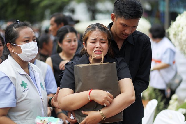 A family member mourns during the cremation ceremony for victims of a school bus fire, at Wat Khao Phraya Sangkharam School, Lan Sak, Uthai Thani province, Thailand, Tuesday, October 8, 2024. (Photo by Chatkla Samnaingjam/AP Photo)