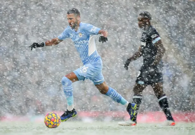 Riyad Mahrez of Manchester City in action as snow falls during the Premier League match between Manchester City and West Ham United at Etihad Stadium on November 28, 2021 in Manchester, England. (Photo by Matt McNulty – Manchester City/Manchester City FC via Getty Images)