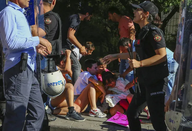 People are detained during the LGBTQ Pride March in Ankara, Turkey, Tuesday, July 5, 2022. (Photo by Ali Unal/AP Photo)