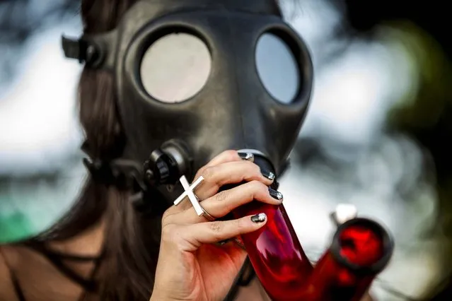 A woman smokes a mask bong on the final day of Hempfest, Seattle's annual gathering to promote the legalization of marijuana, on August 17, 2014. (Photo by Jordan Stead/Seattlepi.com)